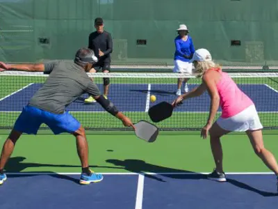 Adults playing pickleball