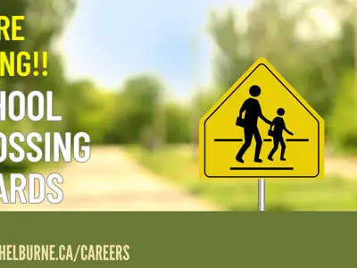 Hiring Crossing Guards image of road sign with people crossing 