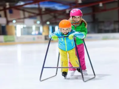 Two children learning to skate