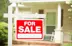 a for sale sign in front of a house