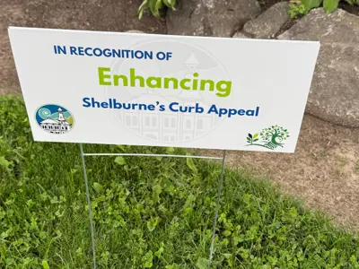 Enhancing Curb Appeal Sign next to gardden