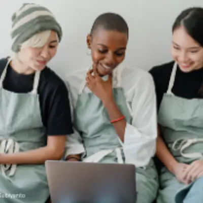 Three people working together on a computer