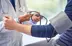 healthcare provider taking blood pressure of client